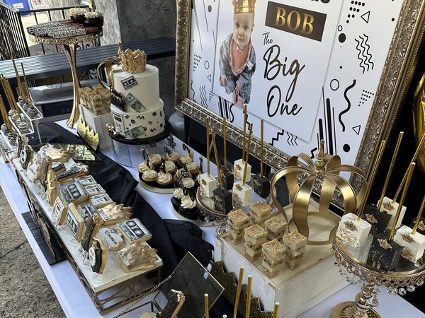 Black and gold Notorious themed dessert table